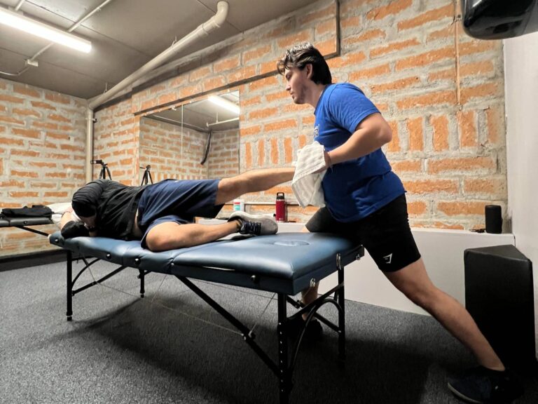 Dr. Cantu performing manual therapy on a patient on the table.